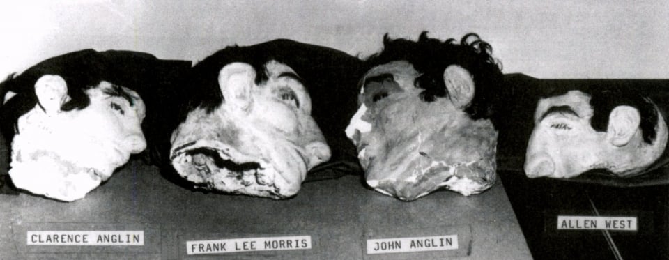 Black and white image of the 4 dummy heads at Alcatraz Island
