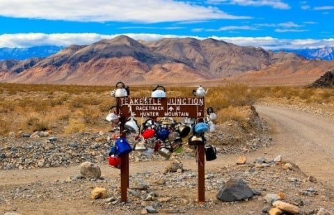 Tea kettles hanging from Death Valley sign
