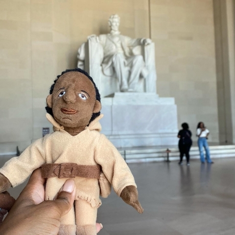 Janina holds up a York doll at the Lincoln Memorial