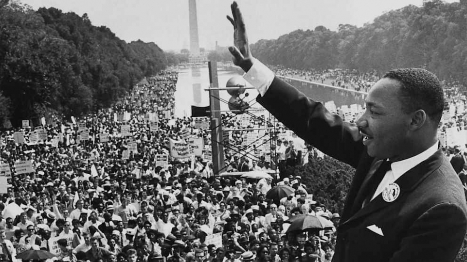 Dr. Martin Luther King, Jr. waves at a crowd gathered for the March on Washington in 1963 on the National Mall