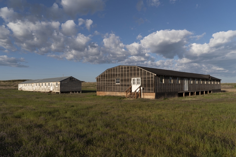 barrack and mess hall with grass and sky