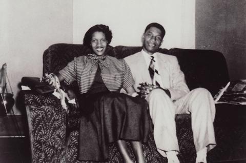 Black and white photo of Myrlie and Medgar Evers sitting on their sofa