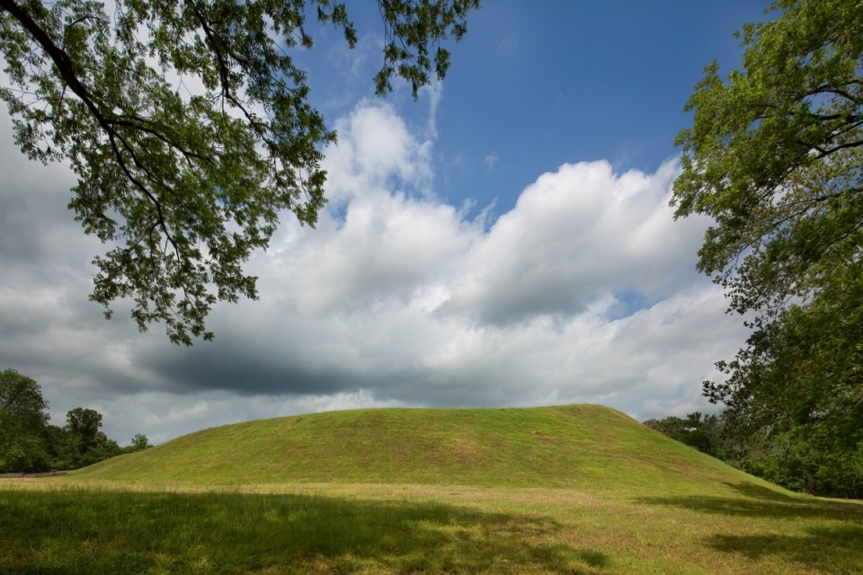A gentle, sloping earthen mound on a sunny day
