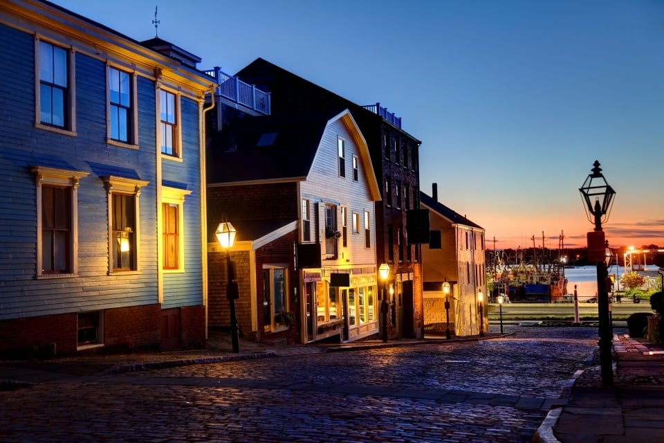 A row of historic buildings and houses at dusk