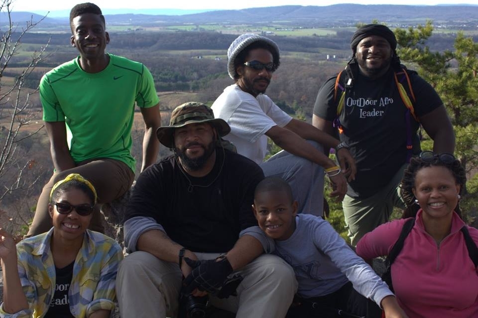 Group of seven African Americans from Outdoor Afro hiking outside.