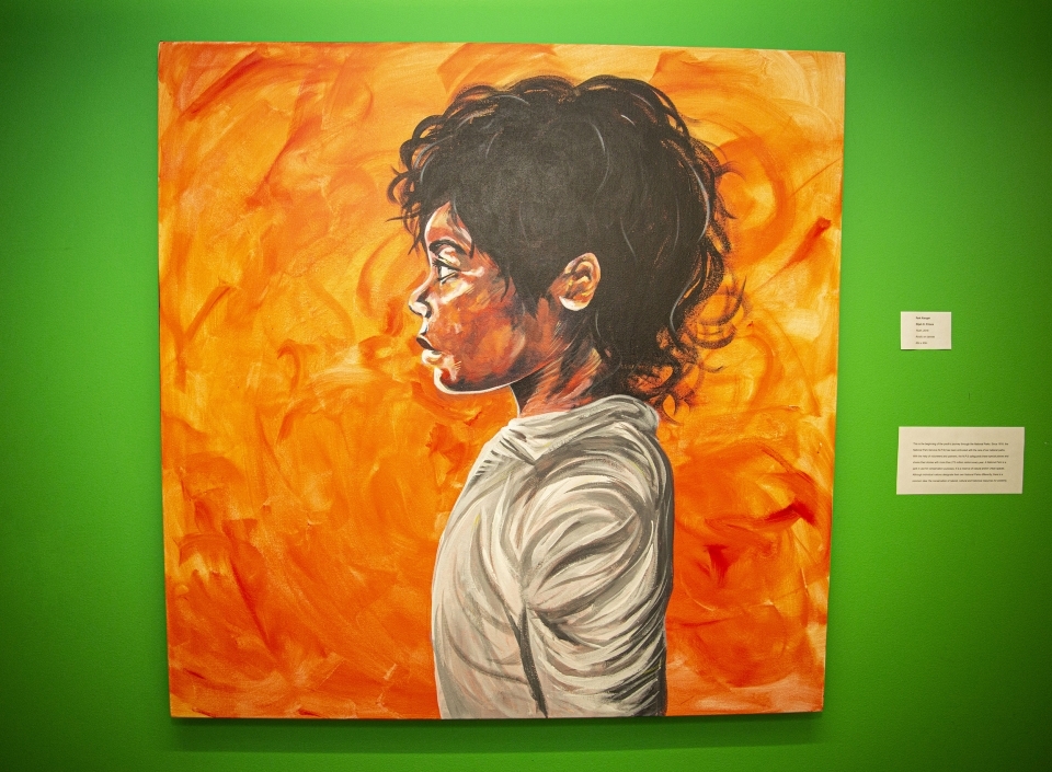 Bright orange painting against a bright green background. Painting of a young woman in a grey sweatshirt looking off to the left.