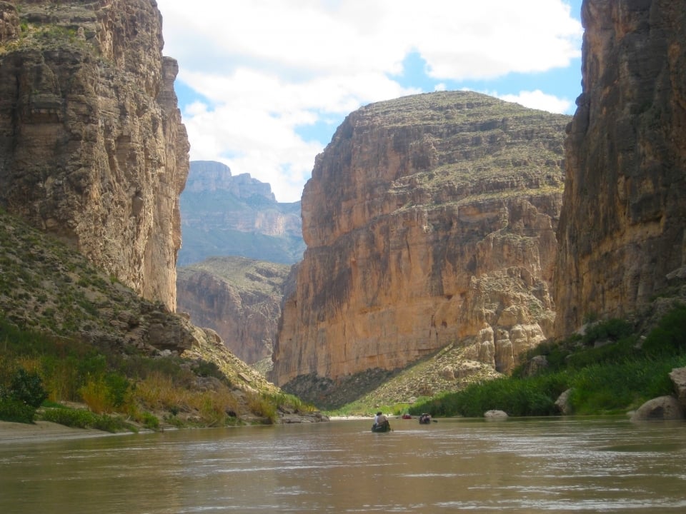 Canoers palling on the Rio Grande Wild & Scenic River in Big Bend National Park towards Boquillas Canyon