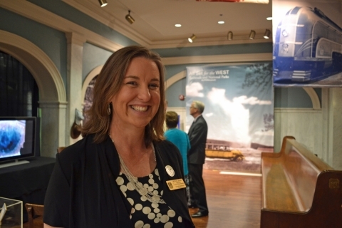 Curator Patricia LaBounty stands in the entrance of a new exhibit on railroads and the national parks
