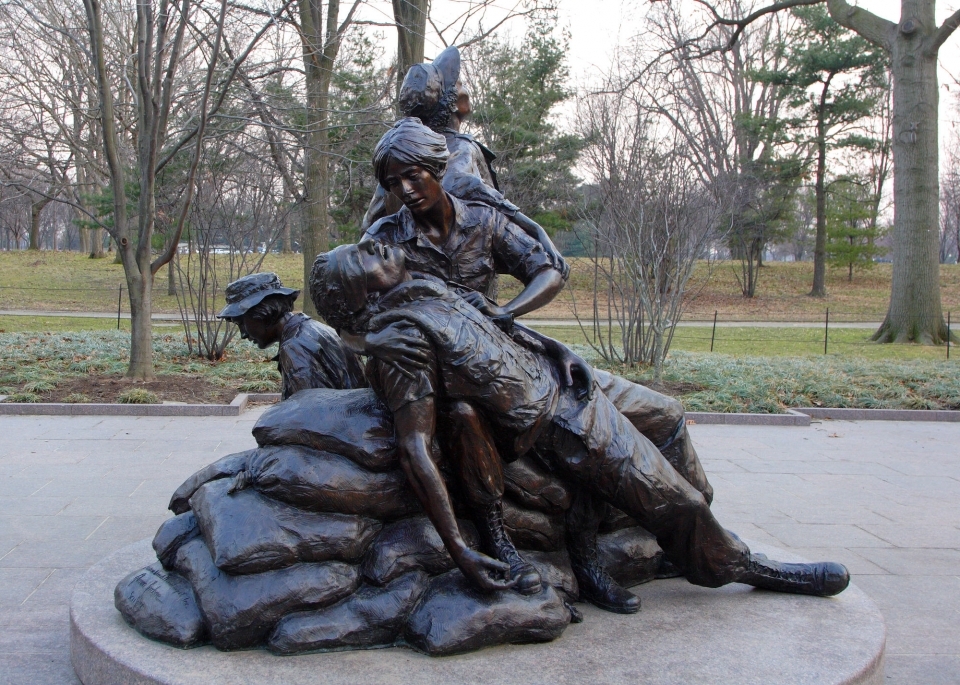 A statue of a woman helping a wounded soldier.