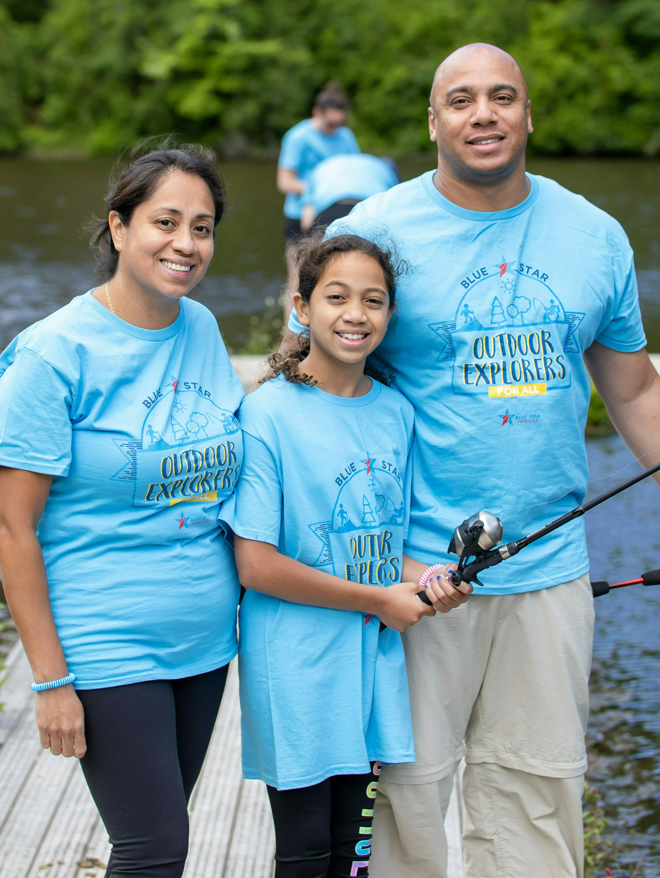 A family poses while learning to fish during a Blue Star Families fishing clinic.